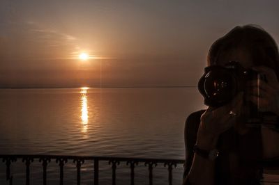 Man standing on beach during sunset