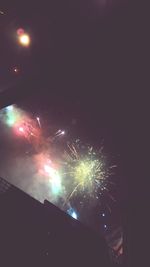 Low angle view of firework display at night