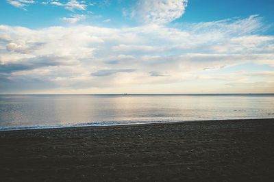 Scenic view of sea against cloudy sky