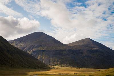 Scenic view of mountains against cloudy sky