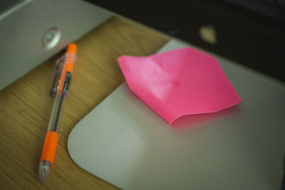 Close-up of heart shape on pink table