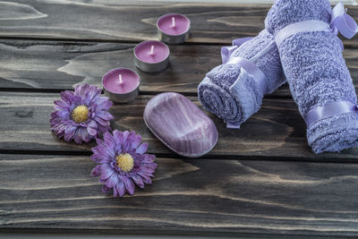 Close up of purple flowers on wooden table