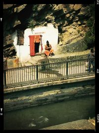 Full length of woman standing on railing