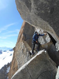 Low angle view of man on snow covered mountain