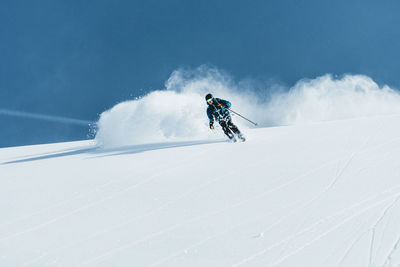 Man enjoying skiing in deep powder snow, gastein, salzburg, austria