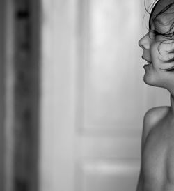 Close-up portrait of young woman against wall