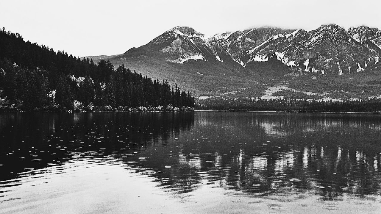 water, mountain, scenics - nature, lake, beauty in nature, reflection, tranquility, tranquil scene, tree, mountain range, sky, snow, nature, black and white, no people, environment, landscape, plant, monochrome, non-urban scene, monochrome photography, land, forest, travel destinations, day, wilderness, cold temperature, pinaceae, winter, coniferous tree, pine woodland, idyllic, outdoors, pine tree, snowcapped mountain, travel