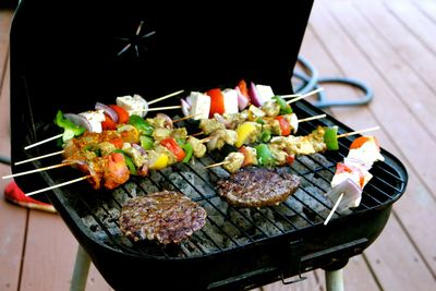 High angle view of meat and kebabs grilling on barbecue