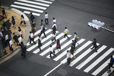 High angle view of people walking on road