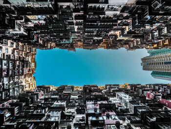 Directly below shot of buildings against sky