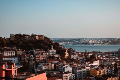 High angle view of townscape by sea against sky