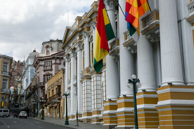 Low angle view of flags against buildings