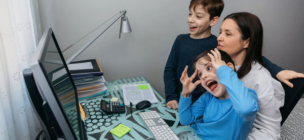 Happy family looking at desktop computer