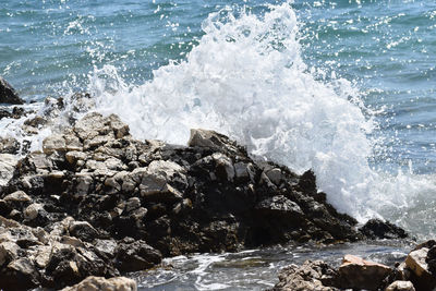 Waves splashing on rocks at shore