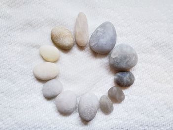 High angle view of pebbles on white surface