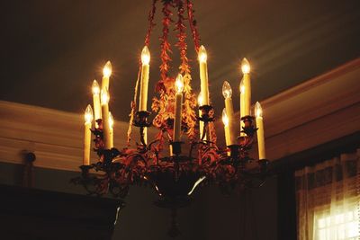 Low angle view of illuminated light bulbs at home