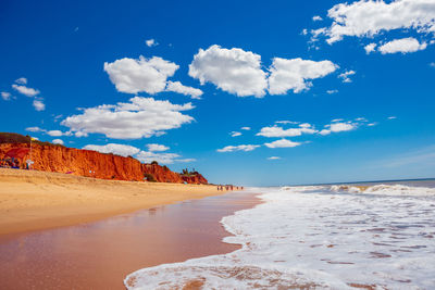 Scenic view of beach against blue sky