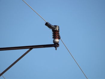 Low angle view of power lines against a cloudless sky