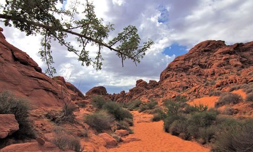 Scenic view of mountains against cloudy sky