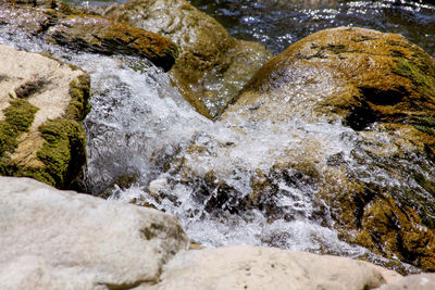 High angle view of water flowing through rocks