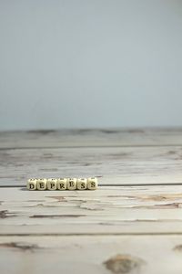 Close-up of coins on table against sky