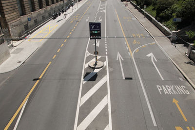 High angle view of road sign on street in city