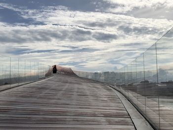 Walkway against sky in city