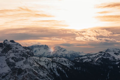 Dramatic colors effect of dolomite winter panorama at sunset with sunlit clouds