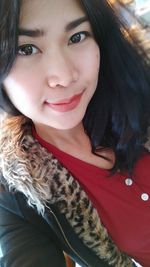 Portrait of smiling young woman in winter