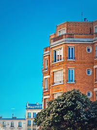 Low angle view of building against clear blue sky