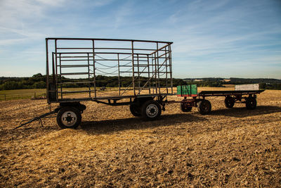Land vehicle
 parked on field against sky