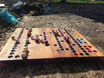 Close-up of chess pieces on sandy beach