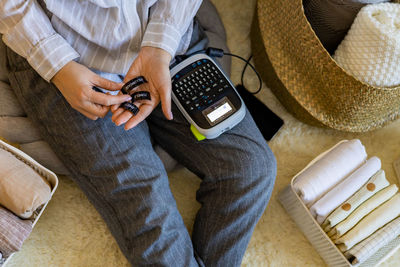 Midsection of woman using calculator