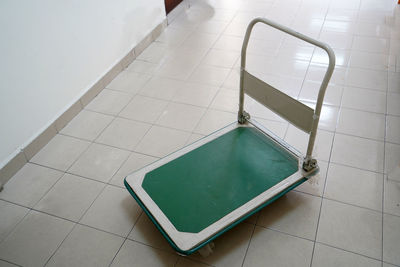 High angle view of tiled floor against wall