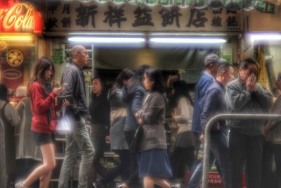 Group of people walking in city at night