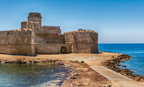 View of the scenic aragonese castle, aka le castella, in the town of isola di capo rizzuto, italy