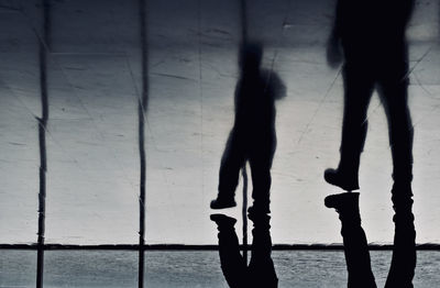 Silhouette people walking on floor