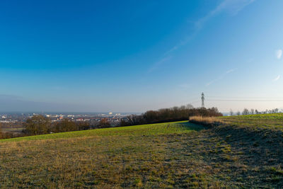 Scenic view of field against blue sky