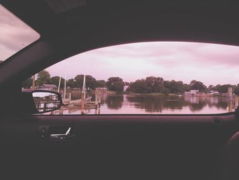 Scenic view of river against sky in city