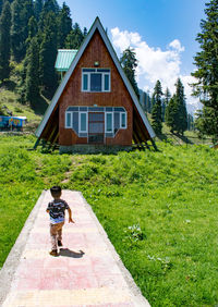 Rear view of man standing on grassy field