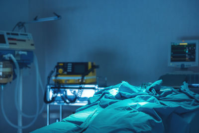 Close-up of illuminated lighting equipment on bed