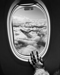 Scenic view of clouds seen through airplane window