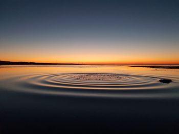 Scenic view of sea against clear sky during sunset