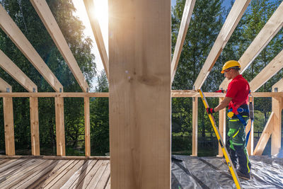 Low angle view of boy standing on railing