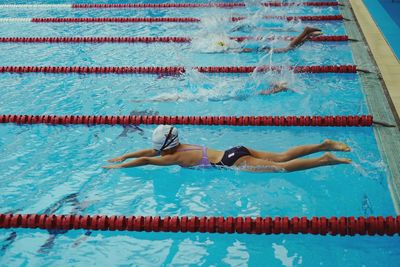 High angle view of men swimming in pool