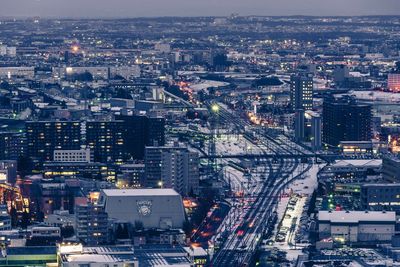 High angle view of city lit up at night