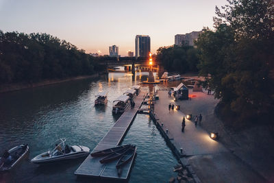 Panoramic view of people in city against sky during sunset