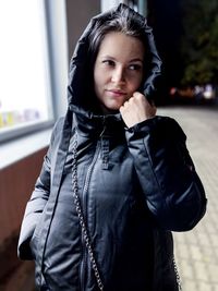 Portrait of smiling young woman standing outdoors