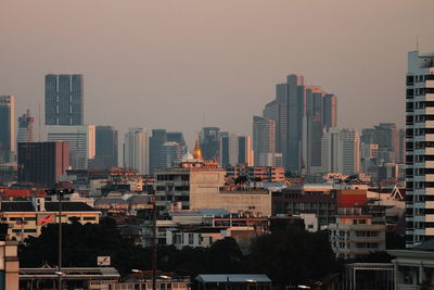 Modern buildings in city against clear sky