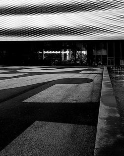 Empty road by buildings in city